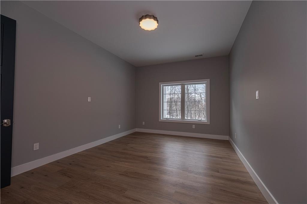 1213 Harrison Court Export, PA 15632 - Photo 36 of 41 a view of an empty room with wooden floor and a window
