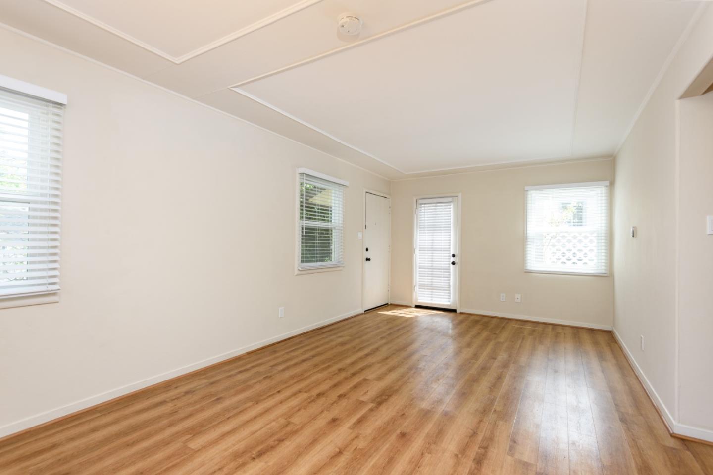 415 Primrose Road Burlingame, CA 94010 - Photo 15 of 23 an empty room with wooden floor and windows