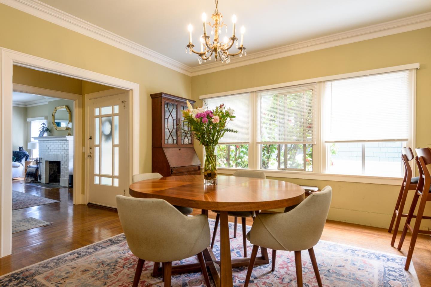 415 Primrose Road Burlingame, CA 94010 - Photo 5 of 23 a dining room with furniture potted plants and wooden floor
