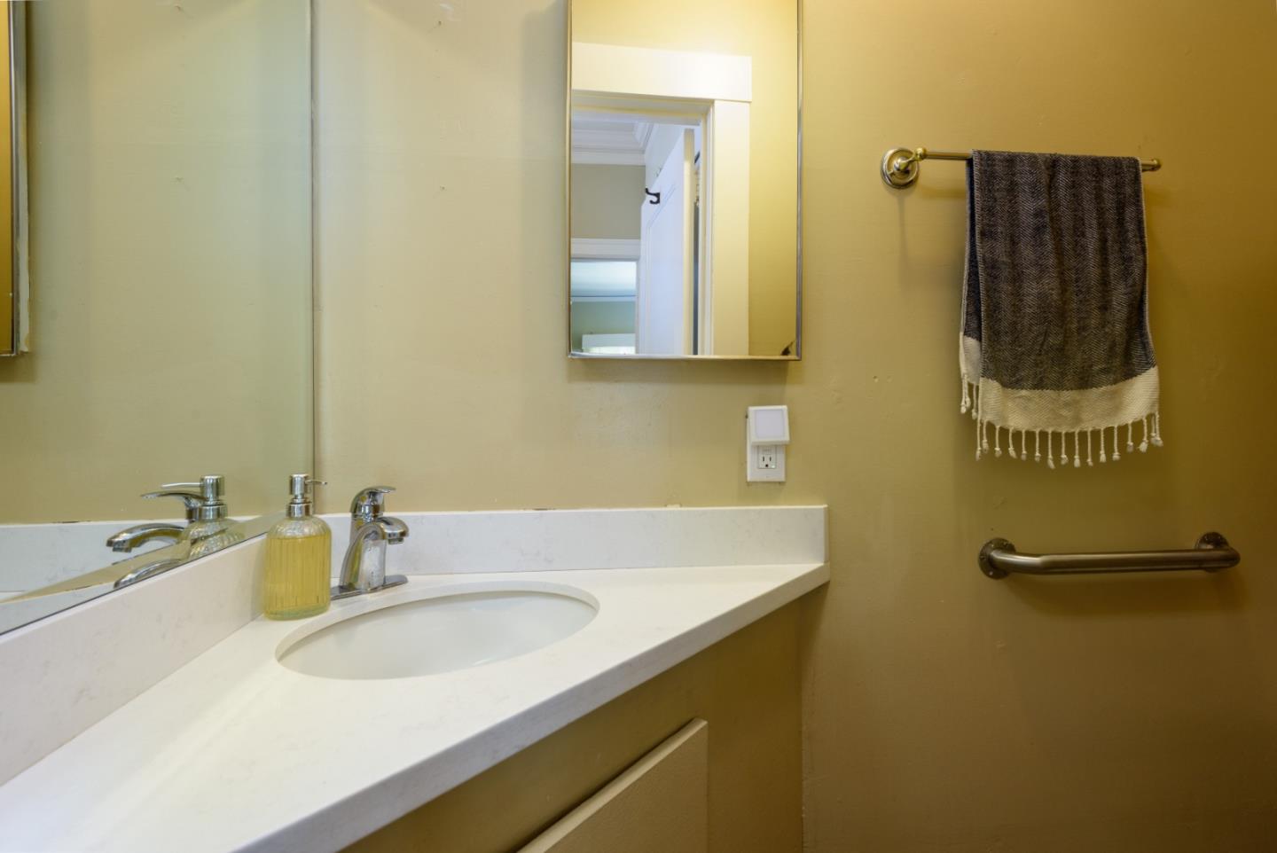415 Primrose Road Burlingame, CA 94010 - Photo 9 of 23 a bathroom with a sink and a mirror