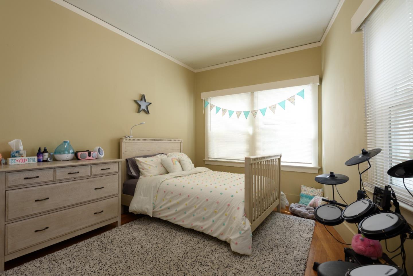 415 Primrose Road Burlingame, CA 94010 - Photo 10 of 23 a bedroom with a bed and a dresser next to a window