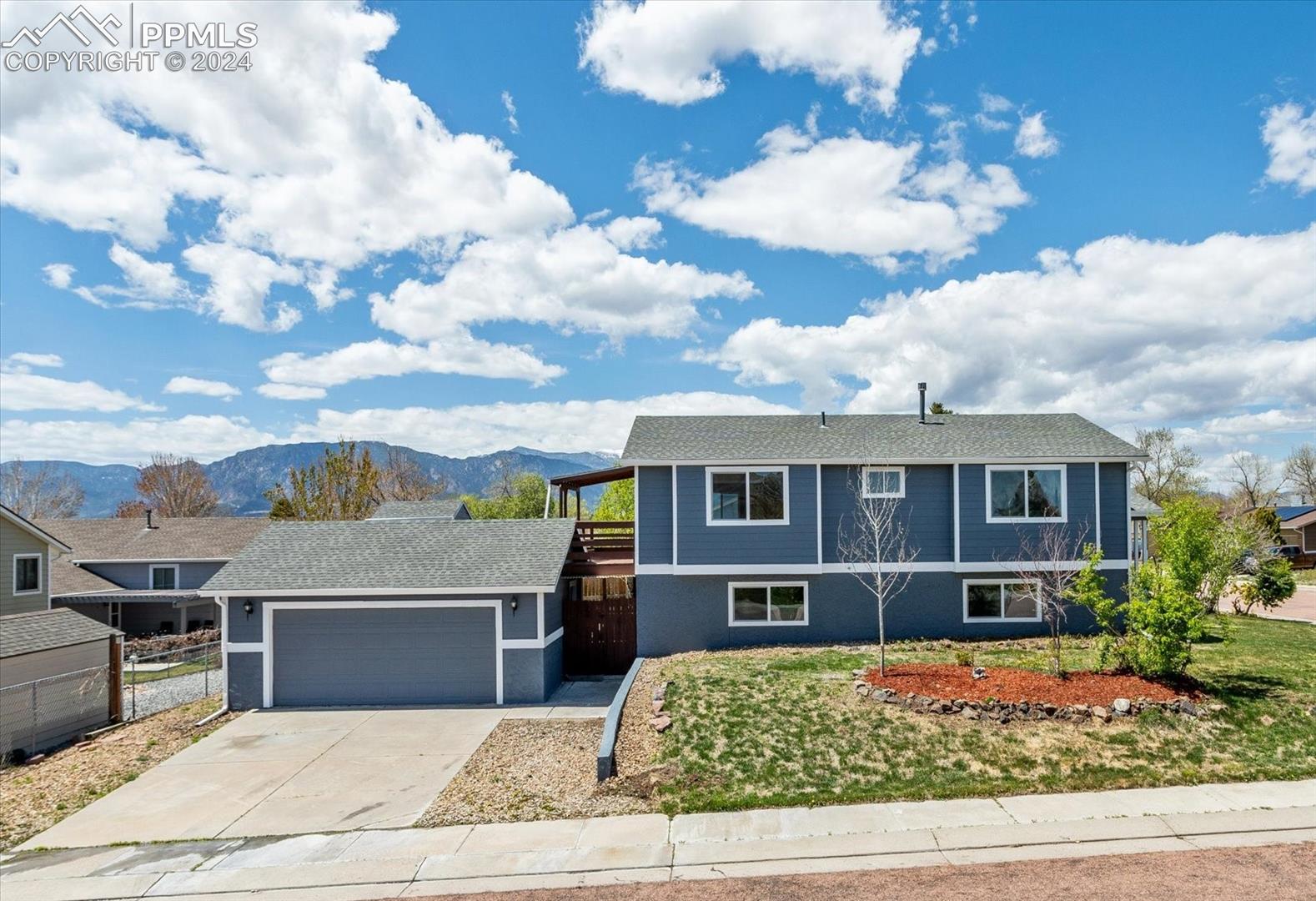 5155 Victory Road Colorado Springs, CO 80911 - Photo 1 of 2 View of front of property with a mountain view and a garage