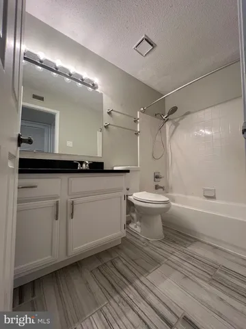 a bathroom with a double vanity sink toilet and shower
