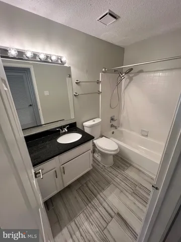 a bathroom with a double vanity sink toilet and shower