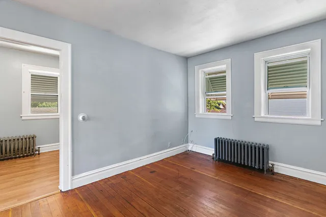 a view of wooden floor and windows in a room