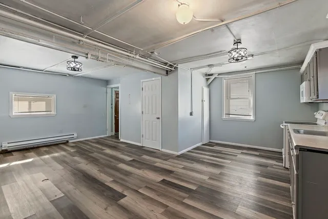 a view of room with window and wooden floor