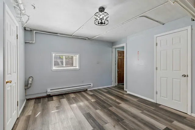 a view of room with window and wooden floor