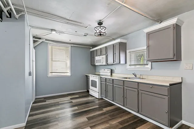 a spacious bathroom with a double vanity sink a mirror and a bathtub