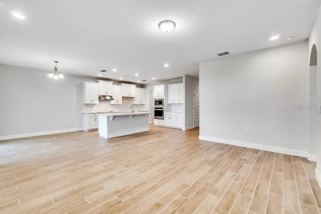 a view of kitchen view wooden floor and window