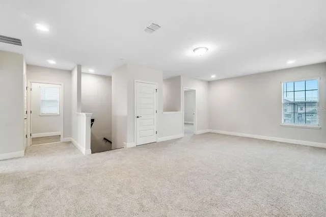 an empty room with windows and closet