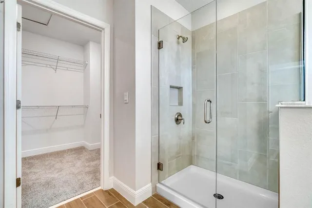 a bathroom with a glass shower door
