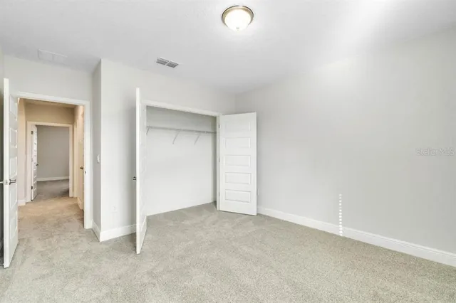 an empty room with closet area