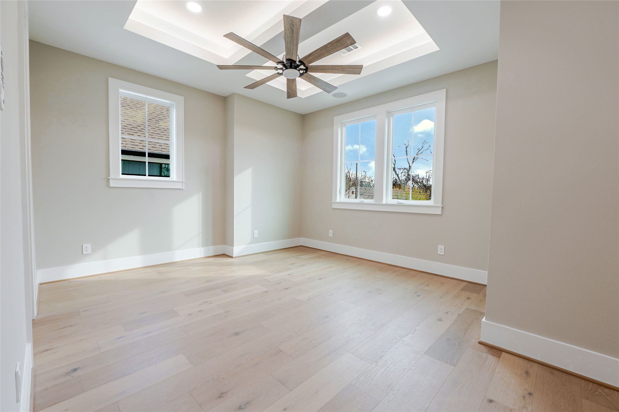 3100 Garwood Street Austin, TX 78702 - Photo 21 of 35 Spare room featuring light wood-style flooring, recessed lighting, a tray ceiling, and ceiling fan