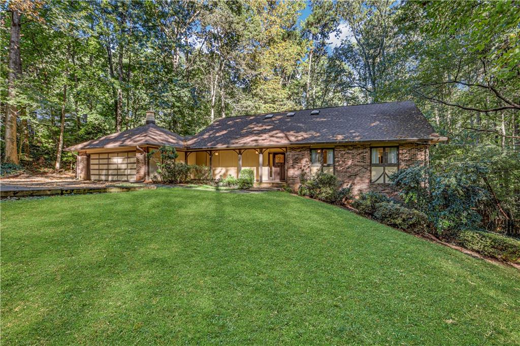 5364 Oxbow Road Smoke Rise, GA 30087 - Photo 1 of 1 a front view of a house with garden