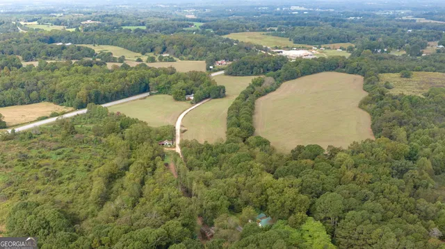 an aerial view of a house with yard