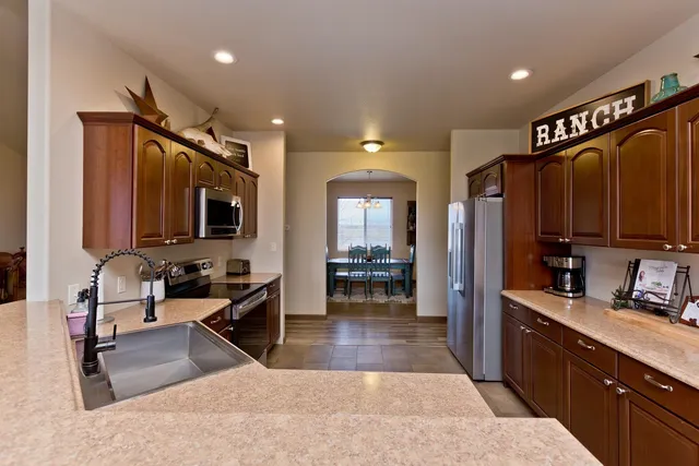 a large kitchen with kitchen island granite countertop a large counter top appliances and cabinets