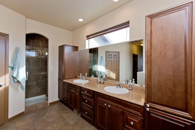 a bathroom with a double vanity sink and mirror