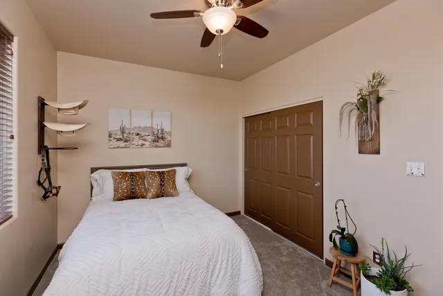 a bedroom with a bed and a chandelier