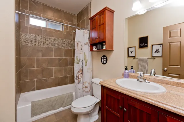 a bathroom with a sink toilet and shower
