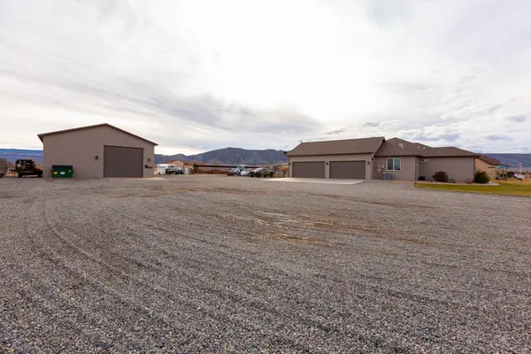 a view of a house with a yard and fence