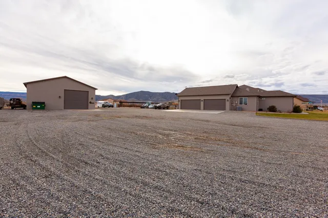 a view of a house with a yard and fence