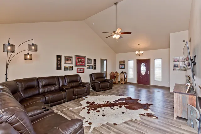 a living room with furniture a couch and wooden floor