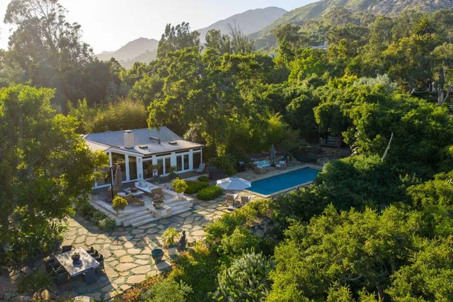 an aerial view of a house with yard swimming pool and outdoor seating