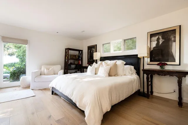 a bedroom with a bed and window