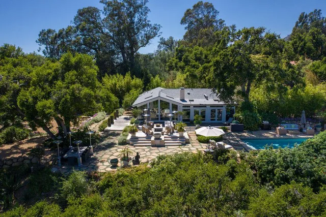 a aerial view of a house with swimming pool and garden