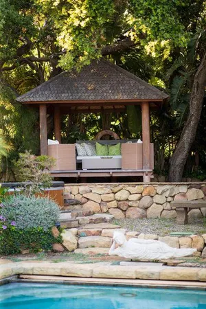 a view of a white house with a sink and yard