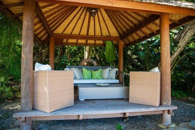 a view of a patio with table and chairs a barbeque with wooden floor and fence