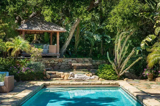 a view of a patio with chairs under an umbrella