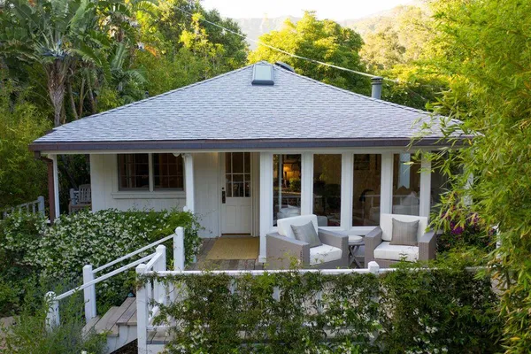 a living room with furniture flat screen tv and a chandelier