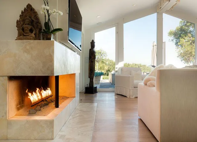 a living room with furniture and a fireplace