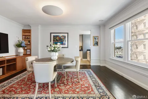 a view of a dining room with furniture window and wooden floor