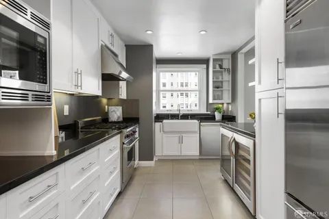 a kitchen with a refrigerator stove and sink