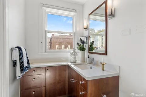 a bathroom with a sink a vanity and a mirror