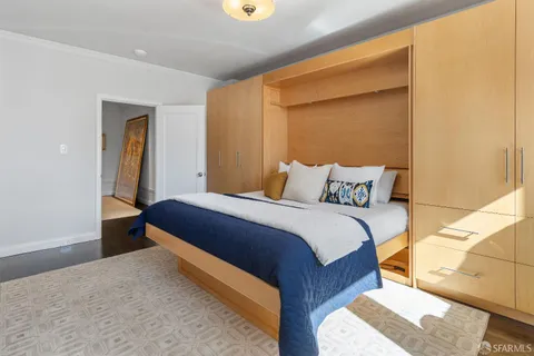 a bedroom with a bed and lamp