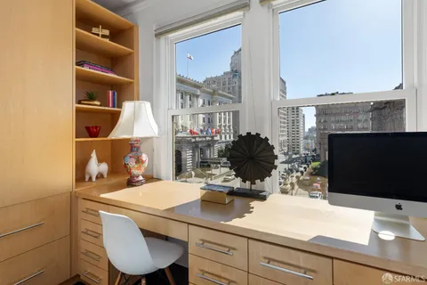 a room with a table chairs and a flat screen tv