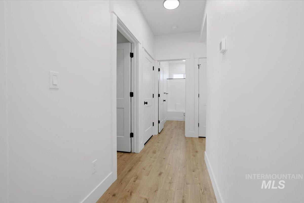 2175 Austin Way Fruitland, ID 83619 - Photo 14 of 30 Hallway featuring baseboards and light wood-style floors