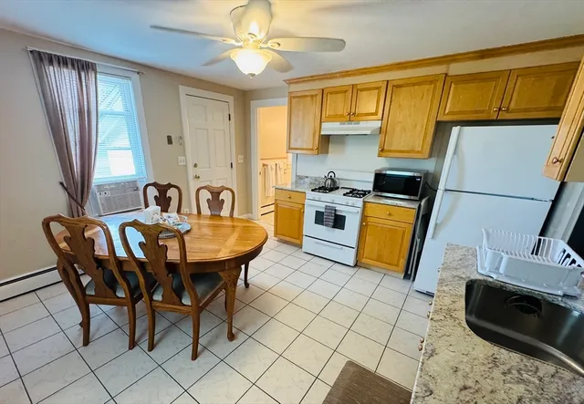 a view of a dining room with furniture and a chandelier