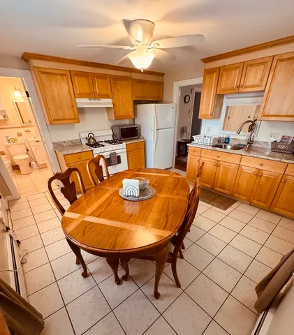 a white toilet sitting next to a bathroom sink and a shower