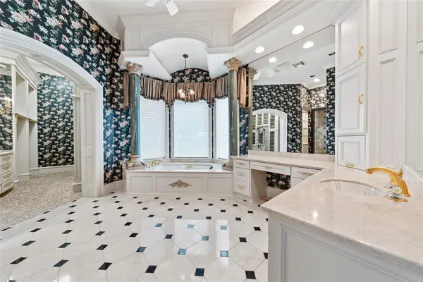 a bathroom with a mirror a sink and a glass door shower