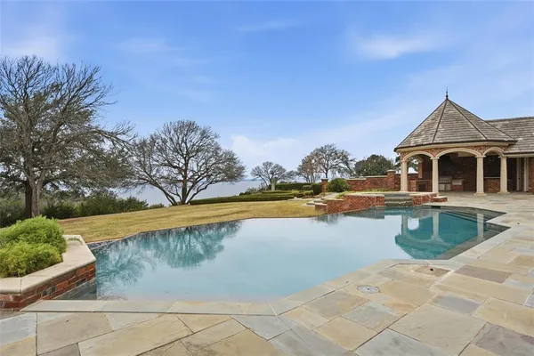 a aerial view of a house with swimming pool and a yard