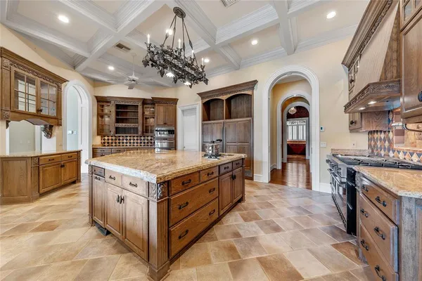 a kitchen with stainless steel appliances granite countertop a stove and a sink