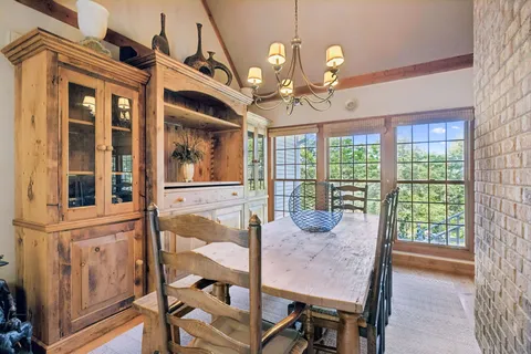 a view of a dining room with furniture and chandelier
