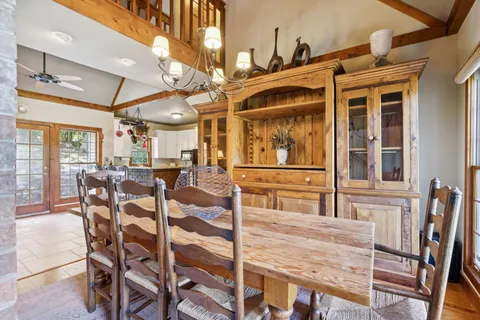 a view of a dining room with furniture and a chandelier