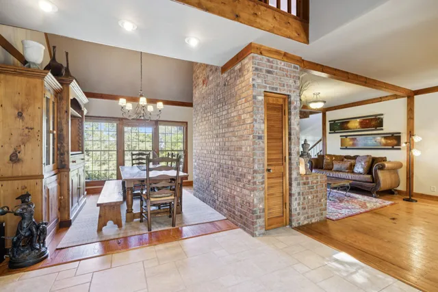 a kitchen with granite countertop a stove a sink and dishwasher with white cabinets