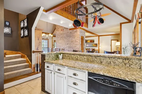 a bed room with a bed and a chandelier