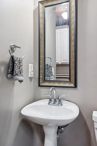 a spacious bathroom with a double vanity sink a mirror and a shower